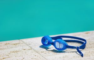 Goggles on side of swimming pool